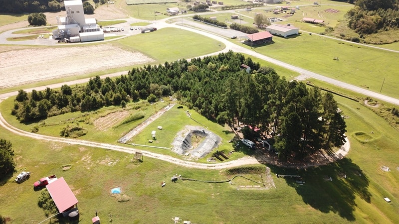 Aerial view of the Sediment and Erosion Control Research and Education Facility at NC State's Lake Wheeler Road Field Laboratory. The image shows demonstrations of erosion and sediment control best management practices, including a skimmer basin and wattle ditch.